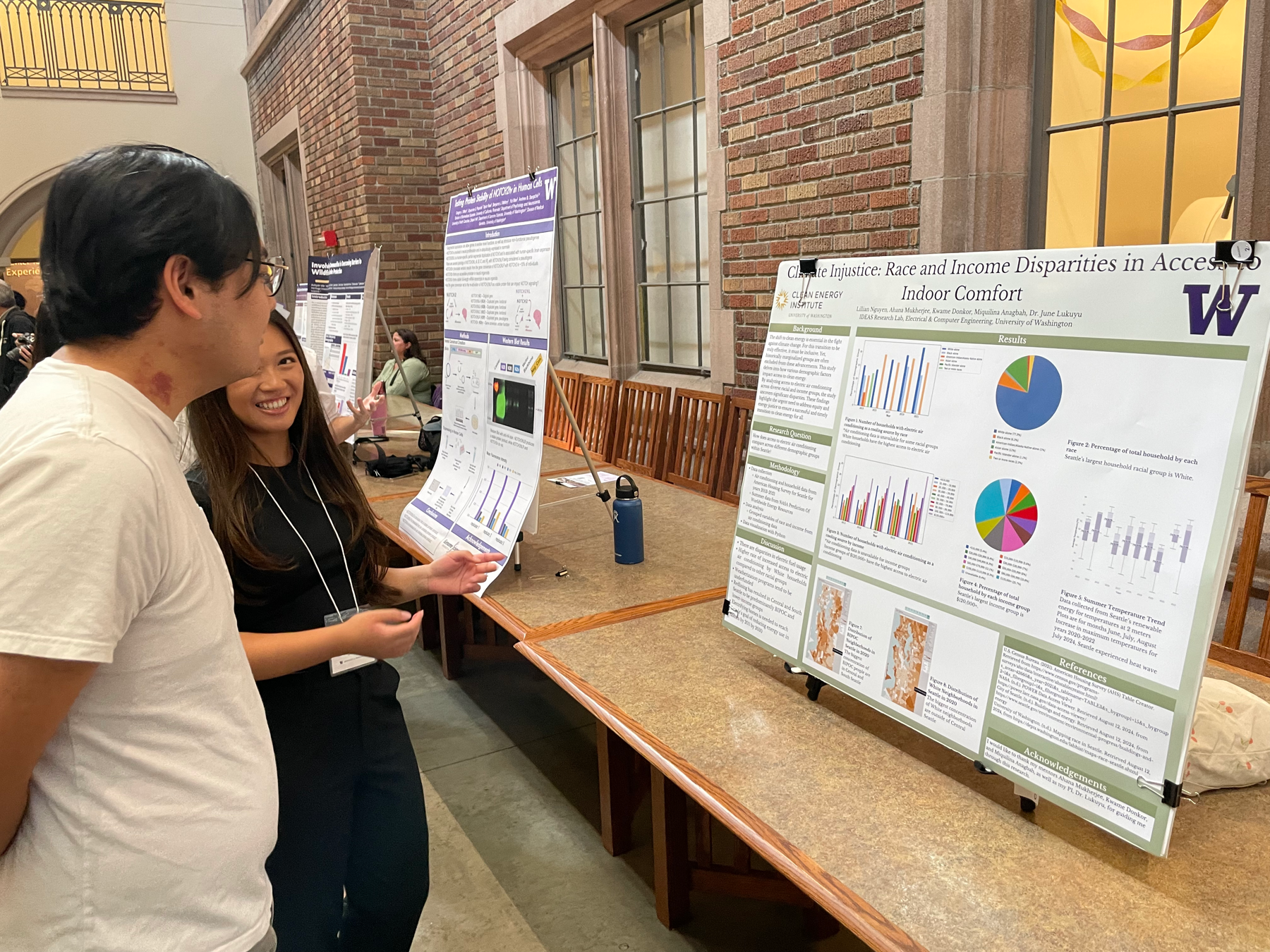 A student discussing a research poster with a visitor